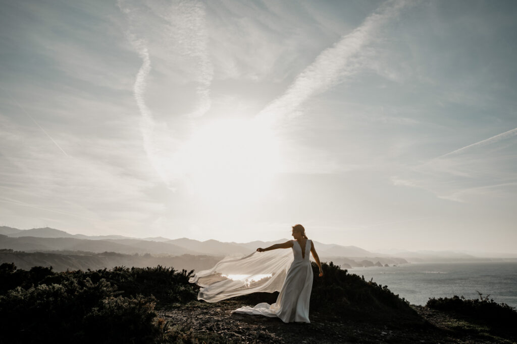 fotografo-boda-natural-asturias novia con capa en una puesta de sol magica